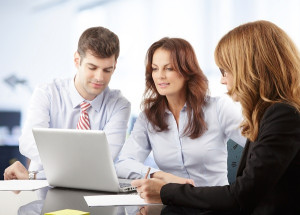 3 people looking at a computer