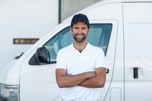 man in front of white commercial vehicle