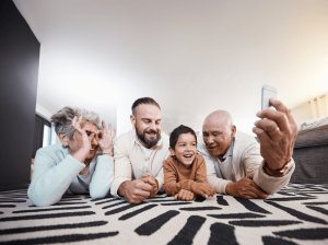 Grandparents on floor taking selfie with grandchild